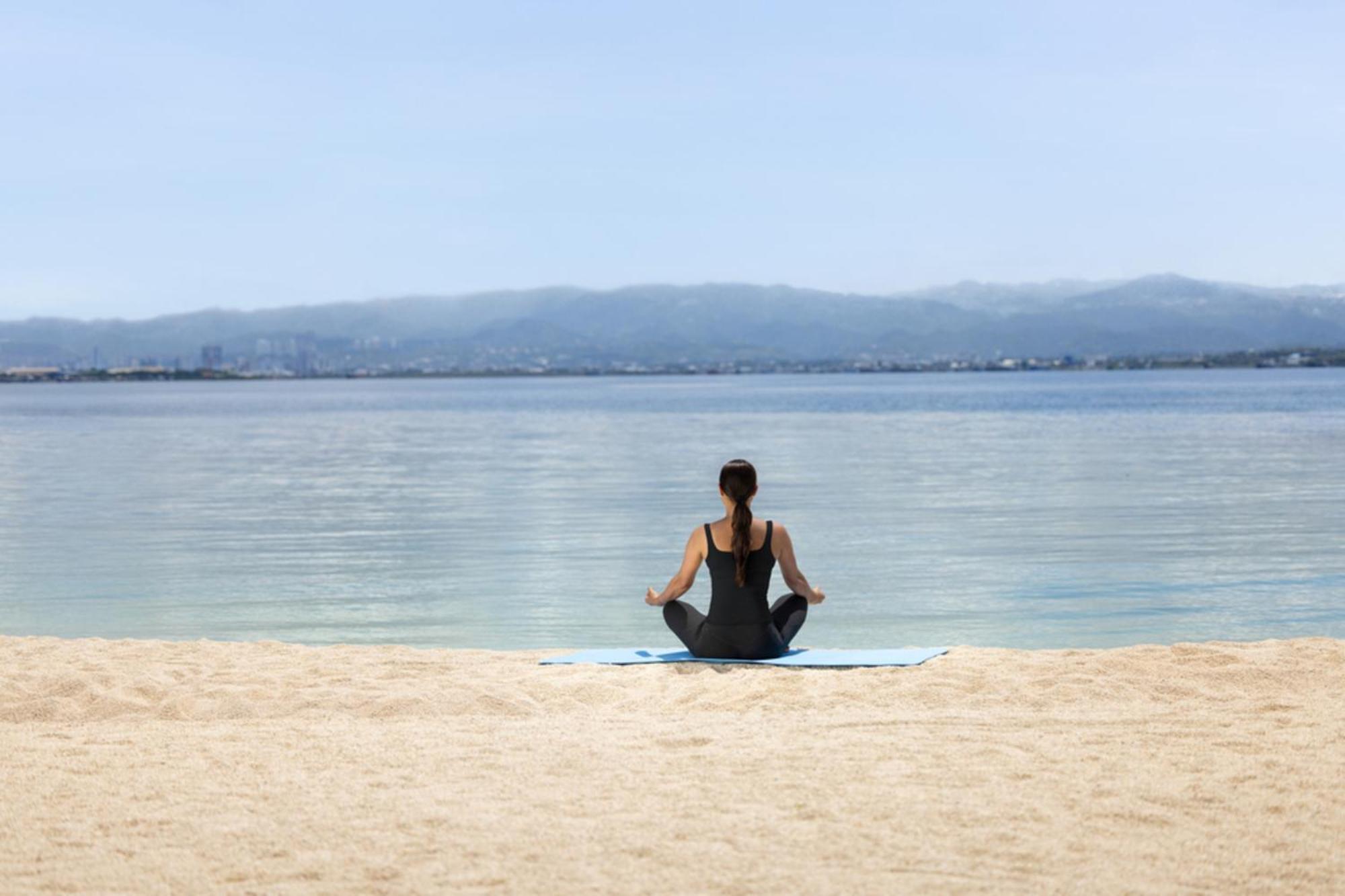 Dusit Thani Mactan Cebu Resort Lapu-Lapu City Exterior photo A woman meditating on a beach